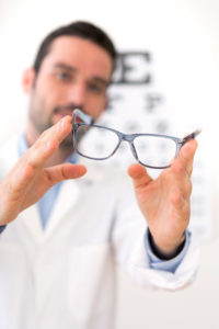 doctor holding glasses
